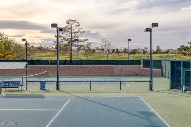 view of tennis court featuring basketball hoop