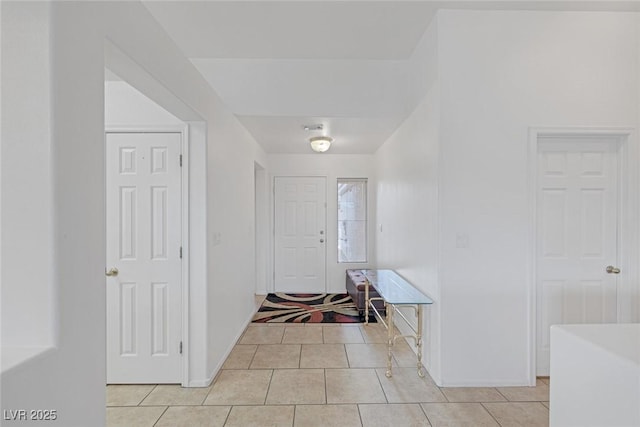 foyer entrance featuring light tile patterned floors