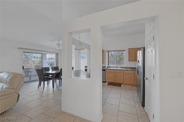 kitchen with pendant lighting, ceiling fan, light tile patterned floors, and stainless steel appliances