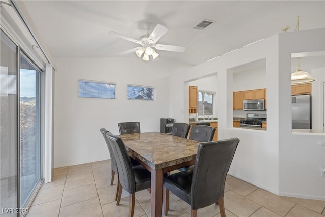 dining space featuring ceiling fan and light tile patterned flooring