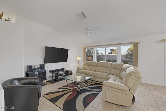 tiled living room with ceiling fan and vaulted ceiling