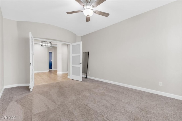 unfurnished bedroom with ceiling fan, carpet, and lofted ceiling