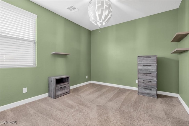 empty room with light colored carpet and a wealth of natural light