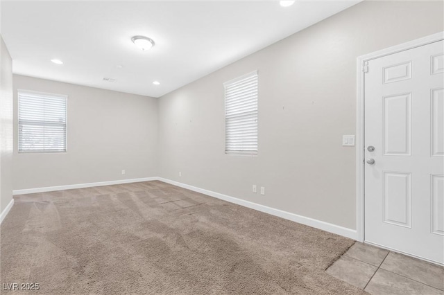 carpeted empty room featuring a wealth of natural light