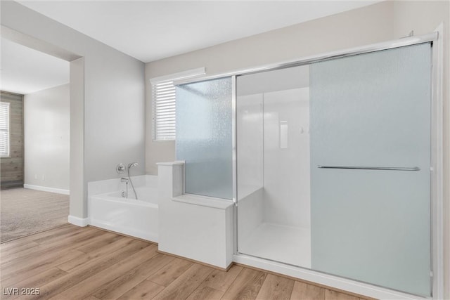 bathroom with plus walk in shower and wood-type flooring