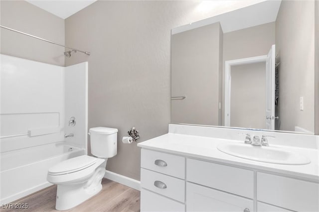 full bathroom featuring hardwood / wood-style flooring, vanity, toilet, and shower / washtub combination