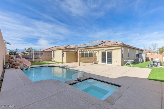 view of pool with an in ground hot tub, a trampoline, a patio area, and central air condition unit