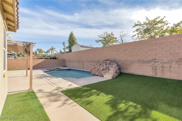 view of pool with a patio area and a yard