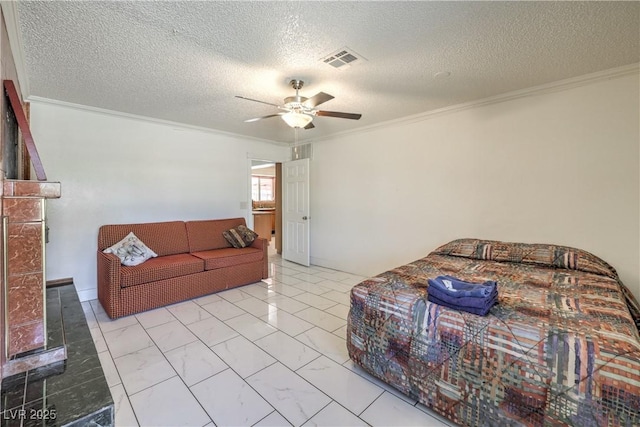 living room with ceiling fan, ornamental molding, and a textured ceiling