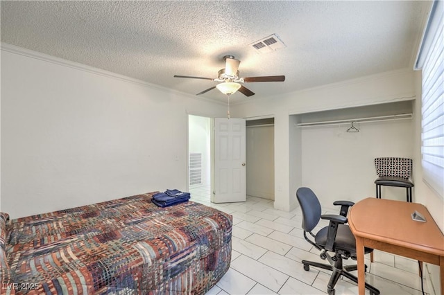 bedroom with ceiling fan, a closet, a textured ceiling, and ornamental molding