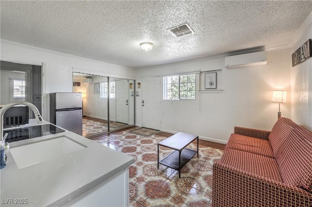 living room featuring a wall mounted AC and a textured ceiling