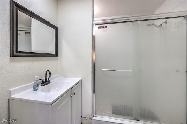 bathroom featuring vanity and an enclosed shower