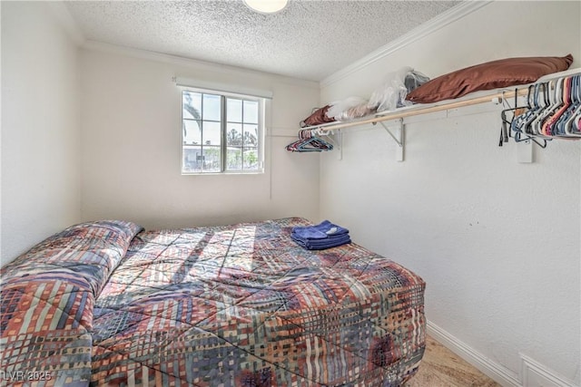 bedroom with a textured ceiling, carpet floors, and ornamental molding