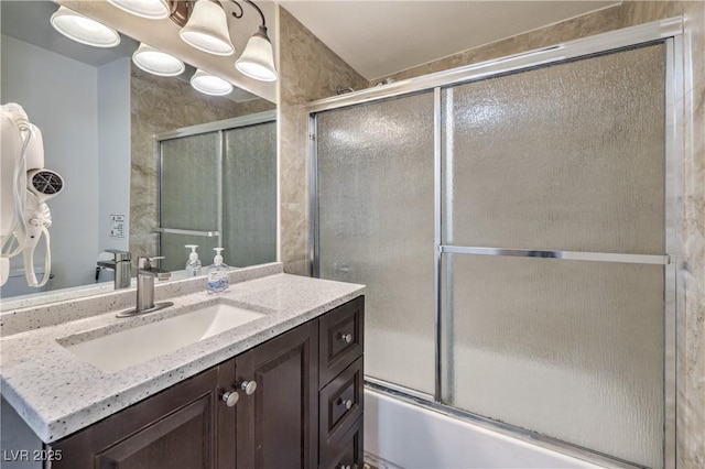 bathroom featuring vanity and enclosed tub / shower combo