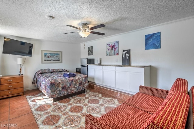 tiled bedroom featuring stainless steel refrigerator, ceiling fan, crown molding, and a textured ceiling