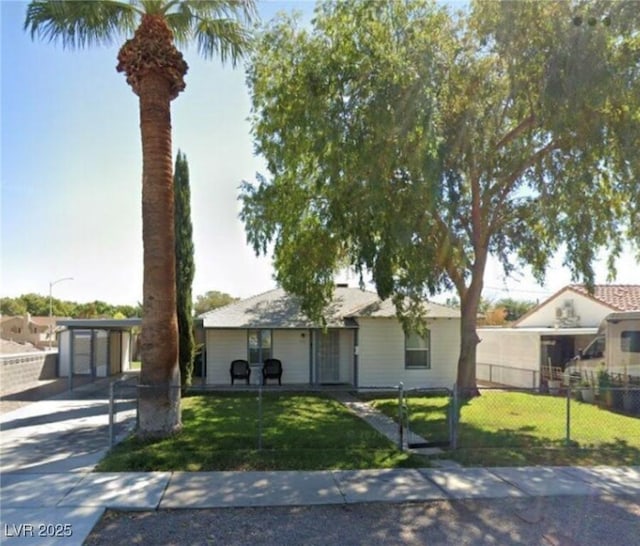 view of front facade with an outbuilding, a front yard, and a garage