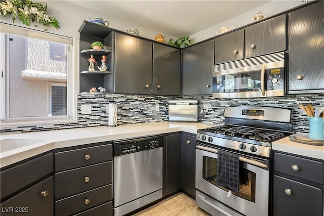 kitchen featuring decorative backsplash, light tile patterned flooring, sink, and stainless steel appliances