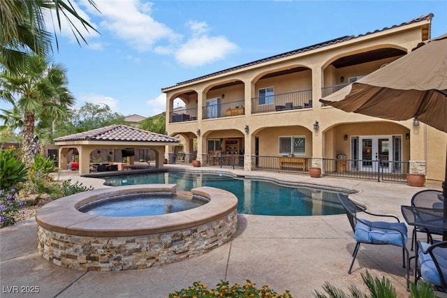 view of pool with an in ground hot tub, french doors, and a patio