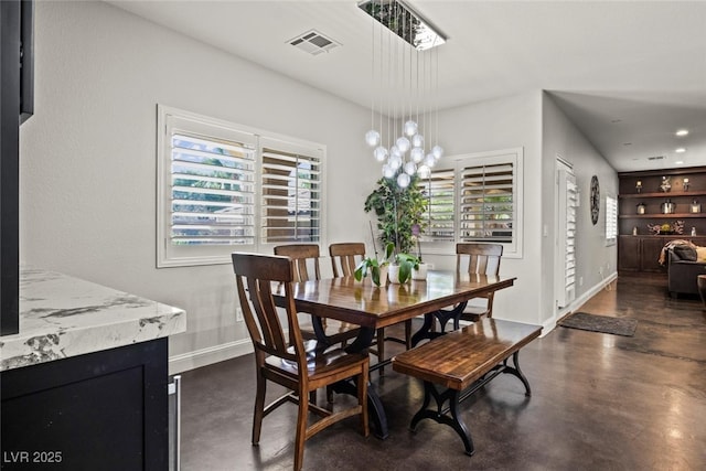 dining room featuring visible vents, baseboards, built in shelves, recessed lighting, and finished concrete flooring