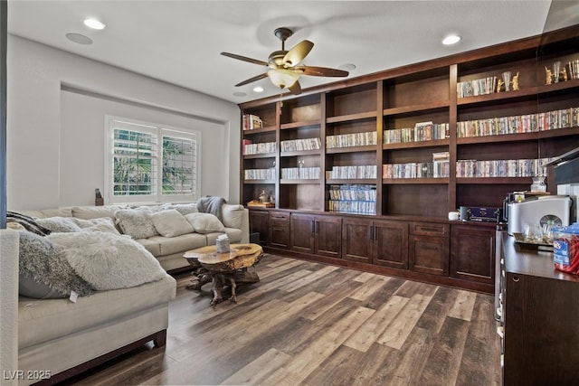 living area featuring dark wood-type flooring, a ceiling fan, and recessed lighting