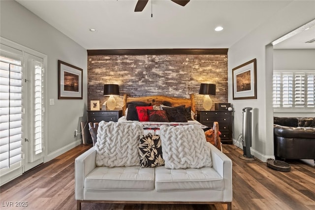 bedroom featuring visible vents, baseboards, ceiling fan, and wood finished floors