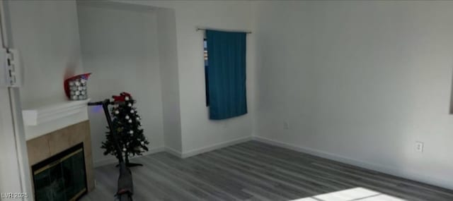 interior space featuring dark hardwood / wood-style flooring and a tile fireplace