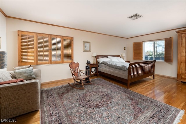 bedroom featuring hardwood / wood-style floors and crown molding