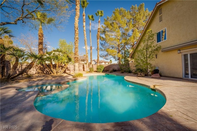 view of pool featuring an in ground hot tub and a patio