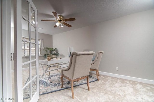 carpeted office featuring ceiling fan and french doors