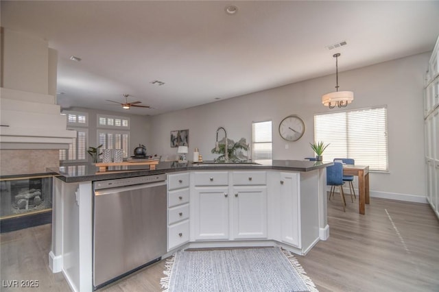 kitchen featuring dishwasher, pendant lighting, white cabinets, and sink