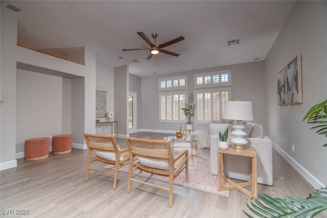 living room featuring light hardwood / wood-style floors and ceiling fan