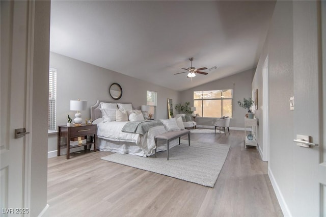 bedroom featuring ceiling fan, light hardwood / wood-style flooring, and vaulted ceiling