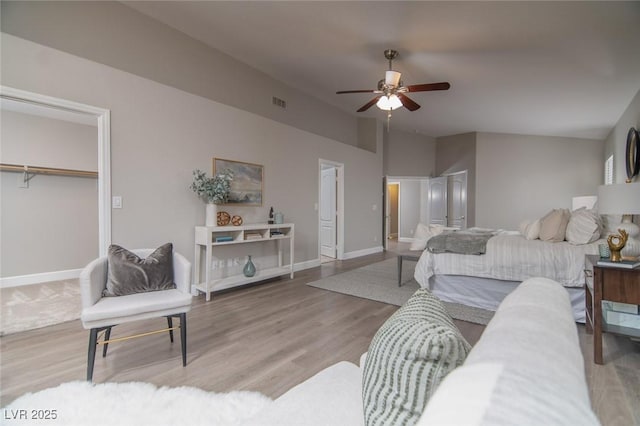 bedroom featuring hardwood / wood-style flooring, ceiling fan, and lofted ceiling