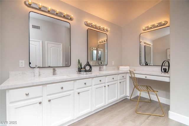 bathroom with vanity and hardwood / wood-style flooring