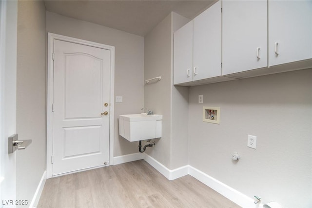 washroom featuring cabinets, hookup for a washing machine, gas dryer hookup, sink, and light hardwood / wood-style flooring