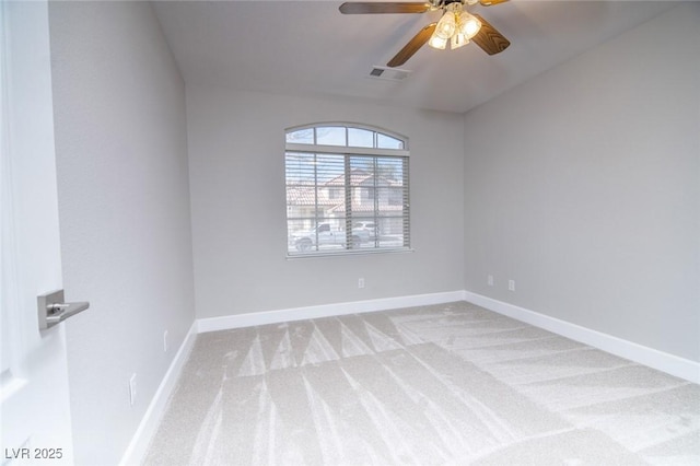 spare room with ceiling fan and light colored carpet