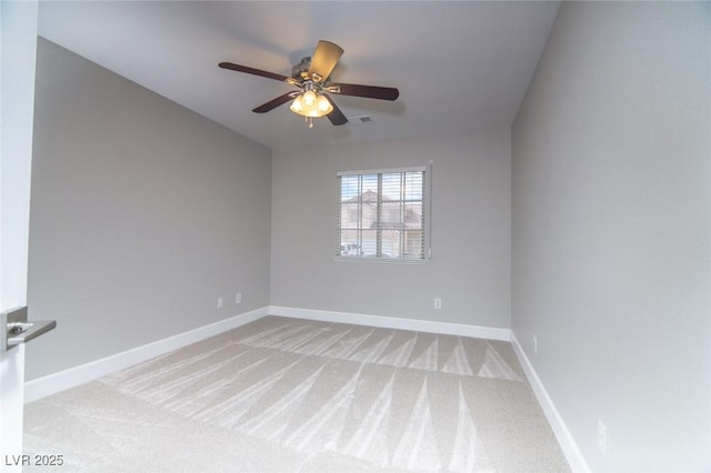 empty room featuring light carpet and ceiling fan