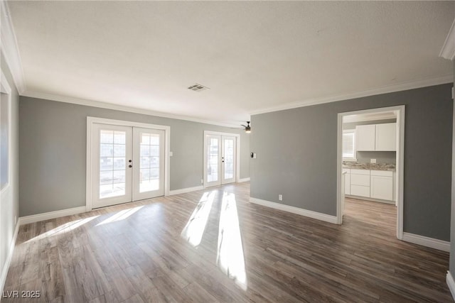 spare room with french doors, ornamental molding, and hardwood / wood-style floors