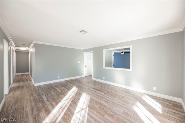 unfurnished room with light wood-type flooring and crown molding