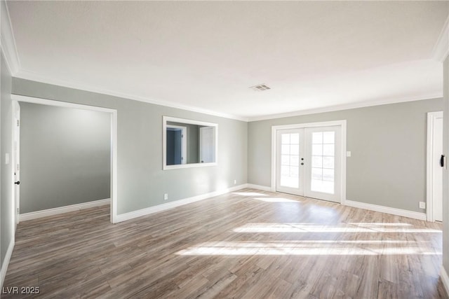 unfurnished room featuring french doors, wood-type flooring, and ornamental molding