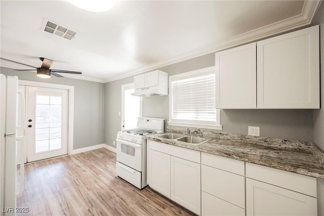 kitchen with white range with gas stovetop, sink, ceiling fan, light wood-type flooring, and white cabinetry