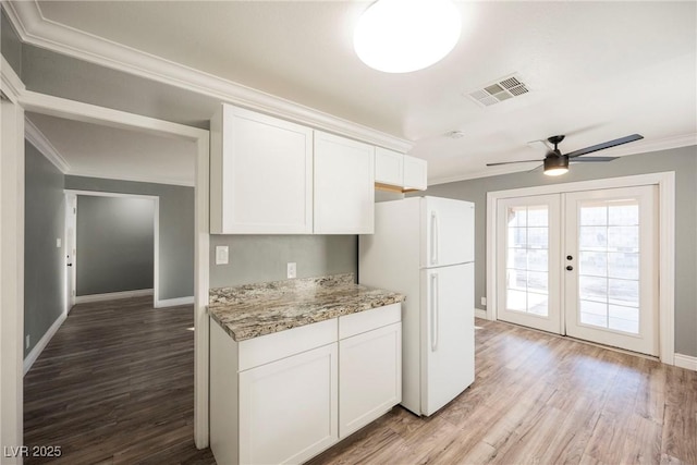 kitchen with white cabinetry, french doors, ceiling fan, hardwood / wood-style floors, and white fridge