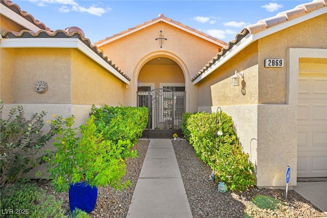 view of exterior entry with a garage