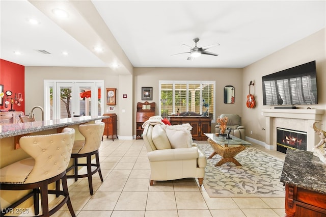 living room featuring ceiling fan, light tile patterned floors, and french doors