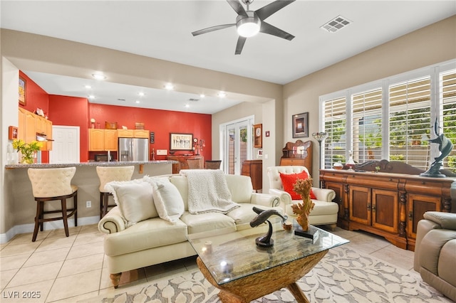 living room with ceiling fan and light tile patterned floors