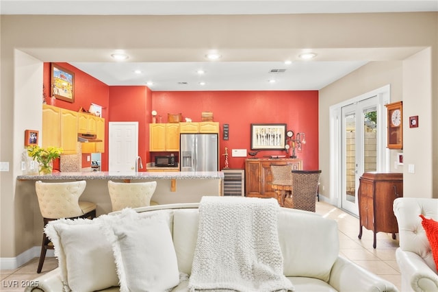 interior space featuring light tile patterned flooring, wine cooler, and french doors