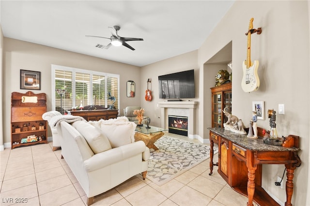 living room with ceiling fan and light tile patterned flooring