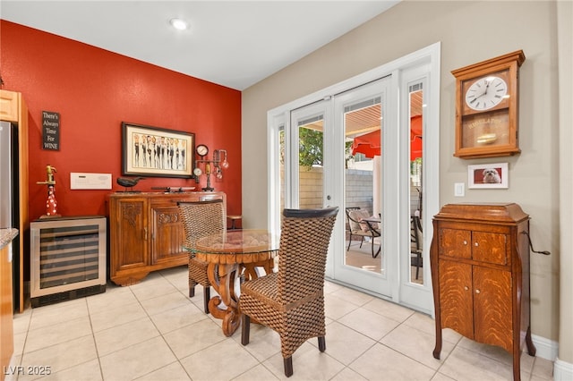 dining room with light tile patterned flooring, beverage cooler, and french doors