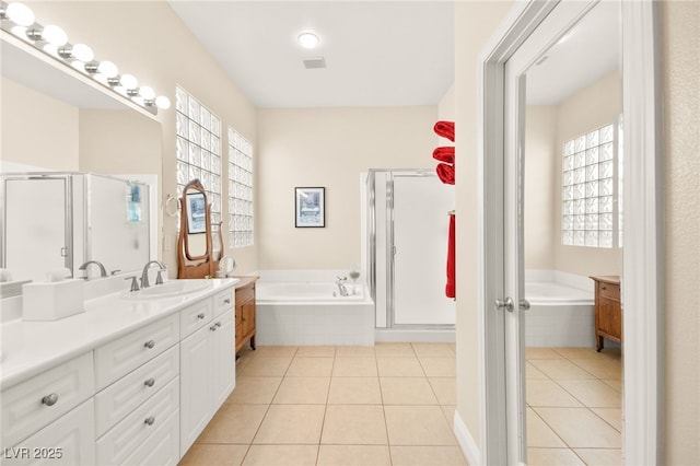 bathroom with tile patterned floors, separate shower and tub, and vanity