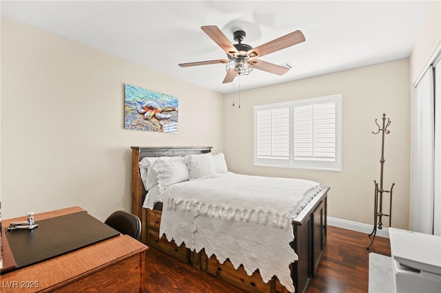 bedroom with a closet, dark hardwood / wood-style floors, and ceiling fan